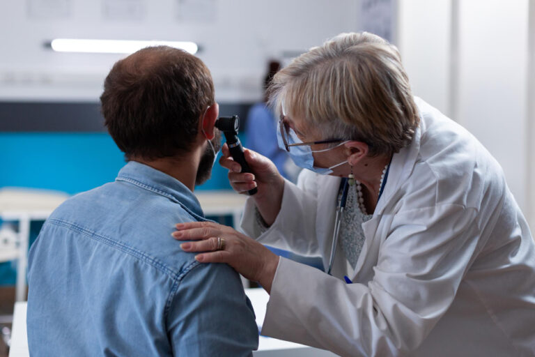 Doctor examining a patient with ear pain